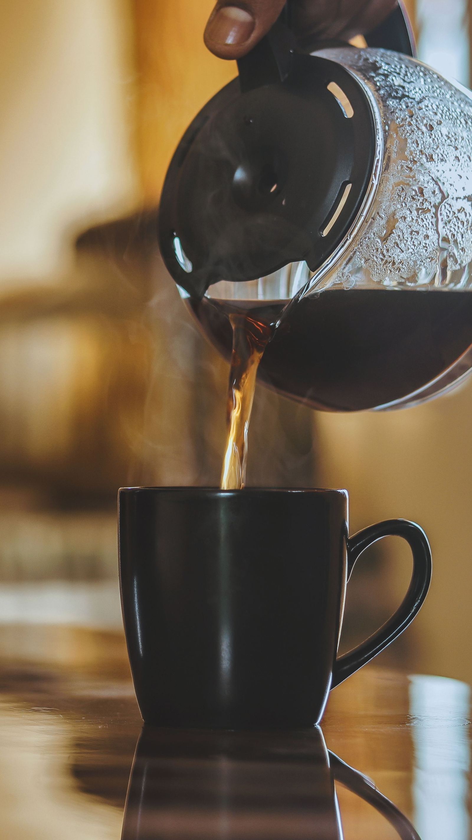 Coffee poured into a black mug.