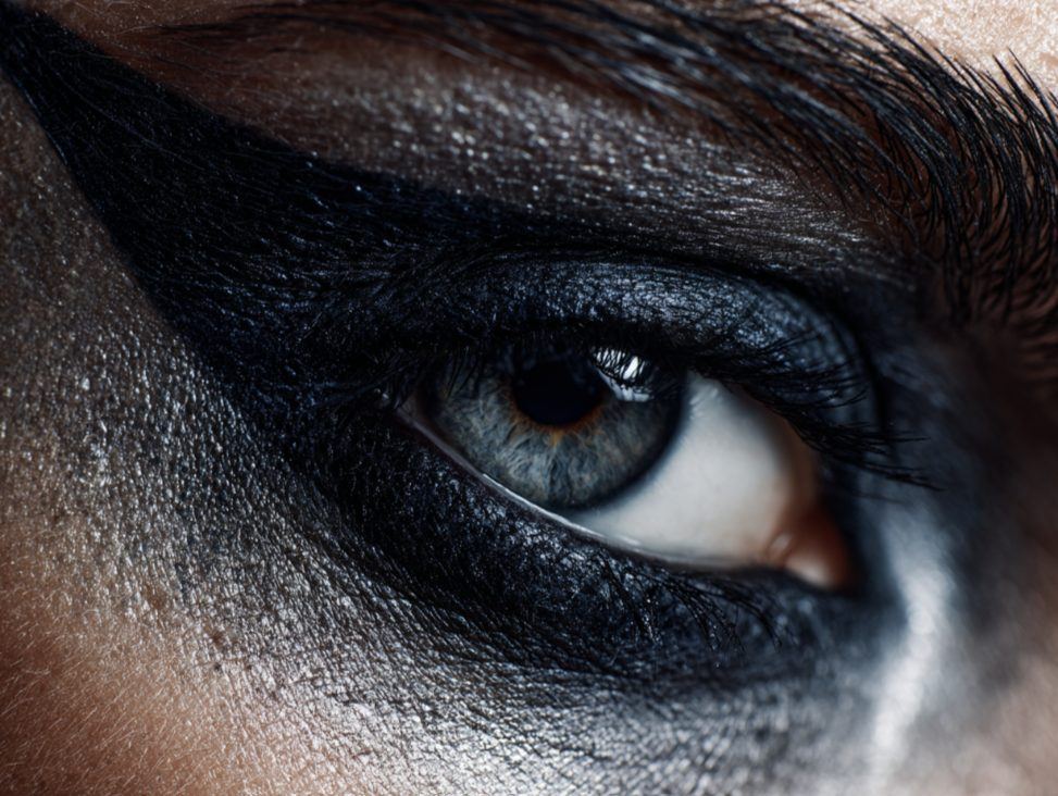 Close-up of a human eye with bold dark makeup.