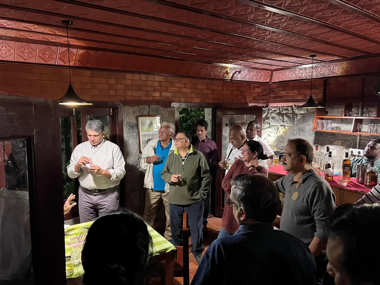 Club members gathered around the dining table beneath a timber ceiling